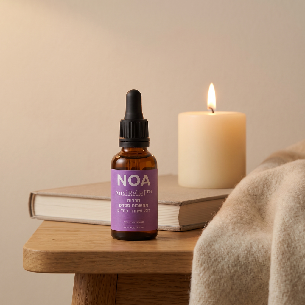 בקבוק NOA AnxiRelief™ 30 מ"ל על שולחן צד עם ספר ונר
