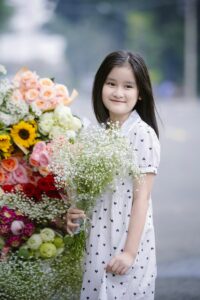 Smiling Girl with Colorful Flowers
