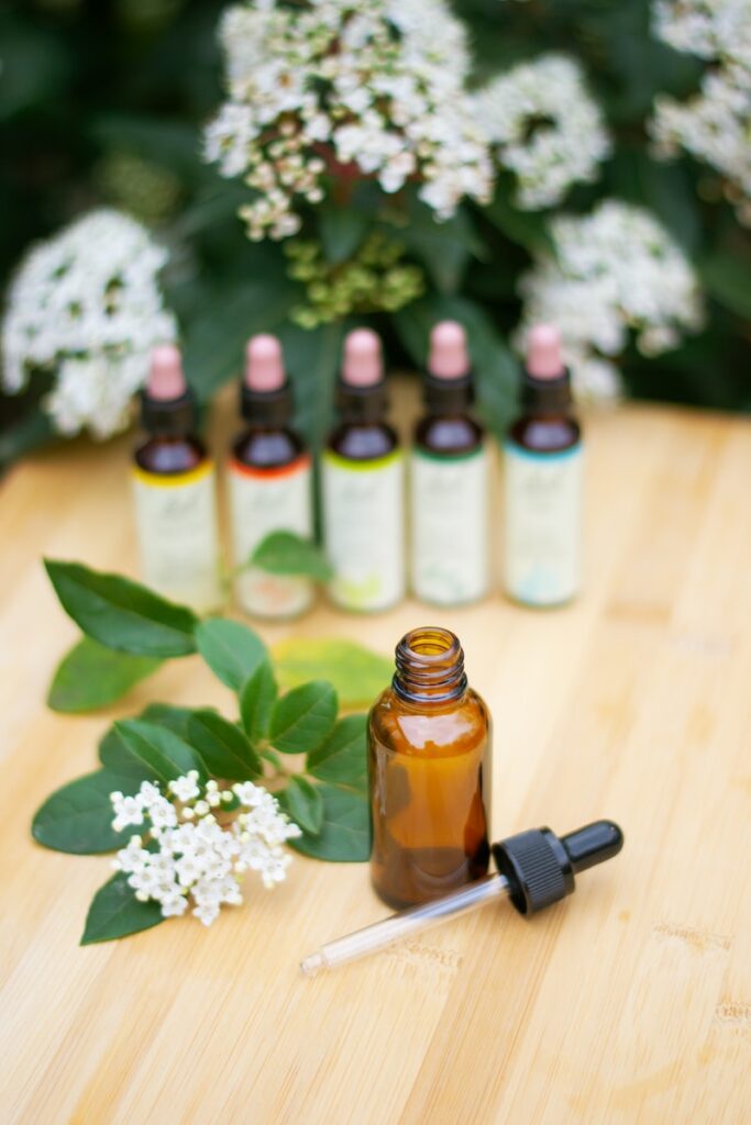 a wooden table topped with bottles of essential oils